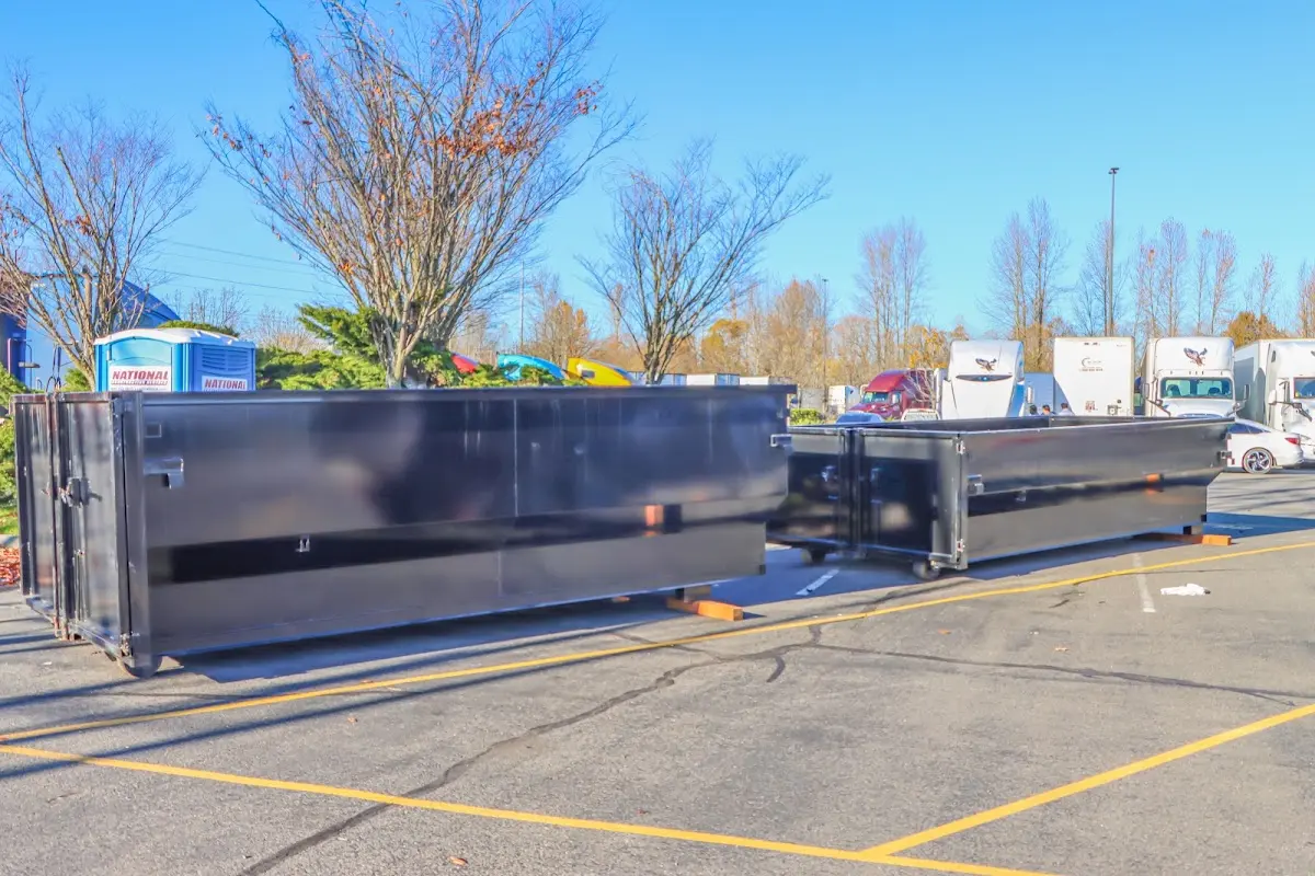 Professional dumpster rental service with roll-off container on residential driveway in Bloomer